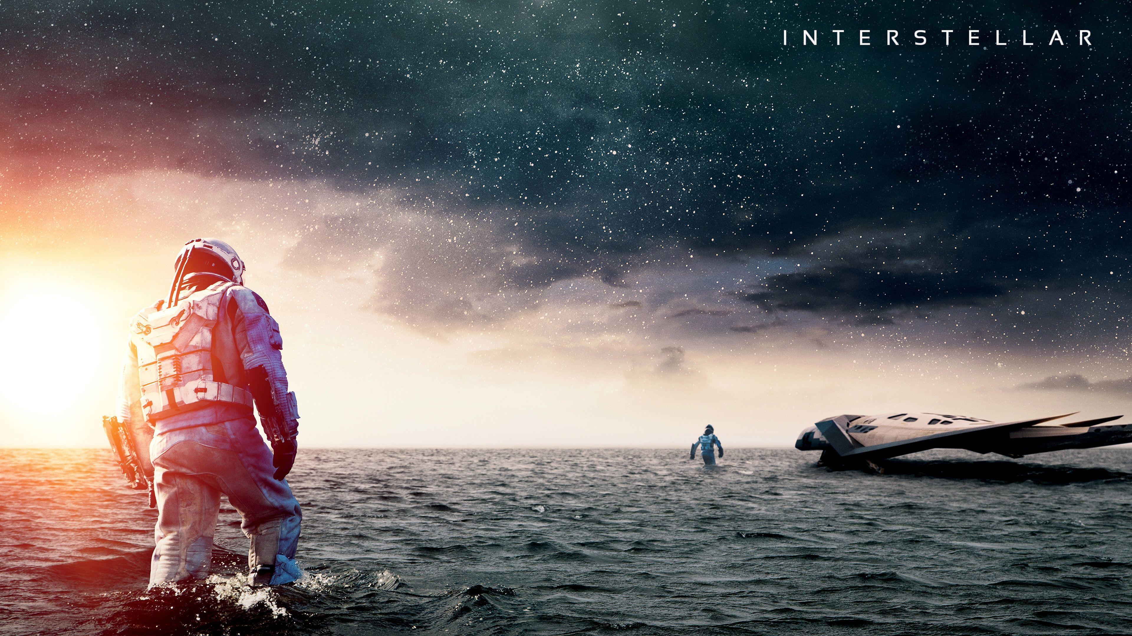 cover of interstellar movie. astronauts on the ocean of another planet