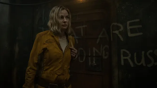 A girl with orange suit looking forward